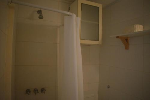 a bathroom with a shower with a shower curtain at Destino Güemes Cozy Studio in Mar del Plata