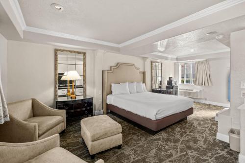 a bedroom with a bed and a chair and a couch at Rose Garden Inn - San Jose Airport in San Jose