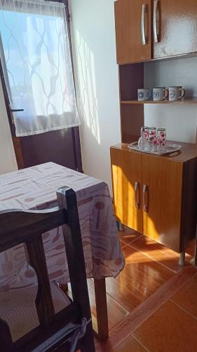 a room with a table and a chair and a cabinet at Rincón del Hum in Mercedes