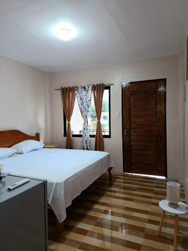 a bedroom with a large bed and a window at Simon Guest House in San Juan