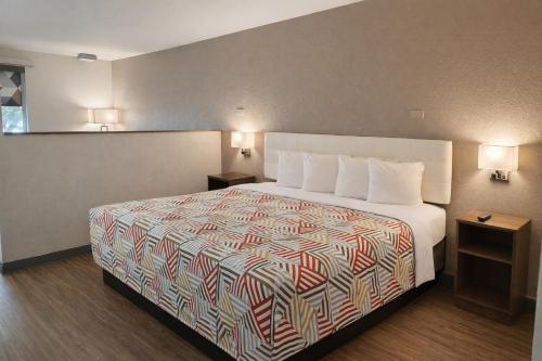 a hotel room with a bed and two night stands at Motel 6 Lake City, FL – Medical Center in Lake City