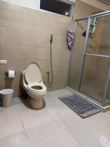 a bathroom with a shower with a toilet and a glass shower stall at Fourth Studio and Festivities in Guararé