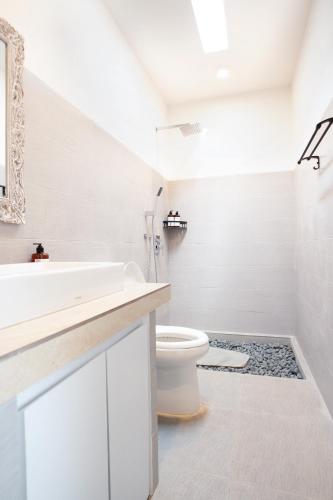 a white bathroom with a sink and a toilet at 2BR Rice Field View Private Villa in Cemagi in Canggu