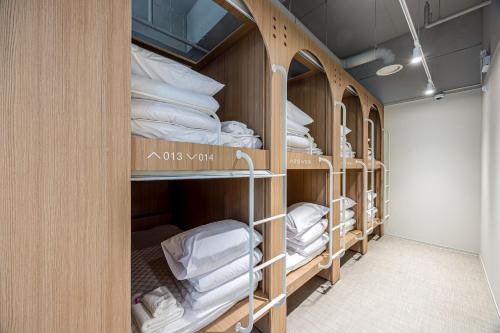 a row of bunk beds in a room at Haeundae Marine Capsule Hotel&Spa in Busan