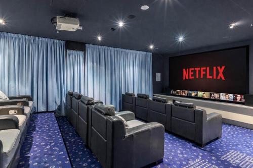 a waiting room with leather chairs and a netflix sign at Stylish Beachside Retreat in Gold Coast