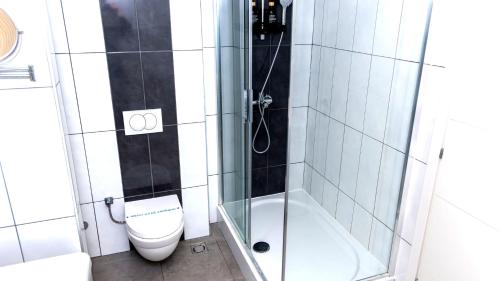 a bathroom with a toilet and a shower at Capitоl Suites & Apartments in Skopje