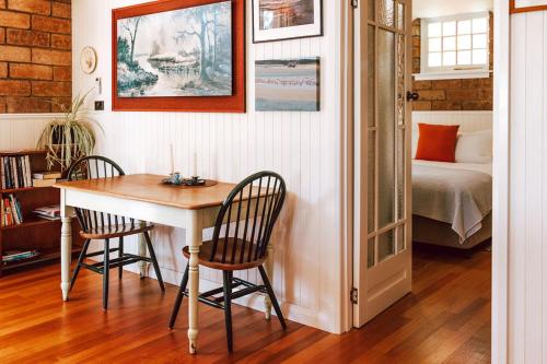 a room with a table and two chairs and a bed at Tillrander - Scamander Retreat in Scamander
