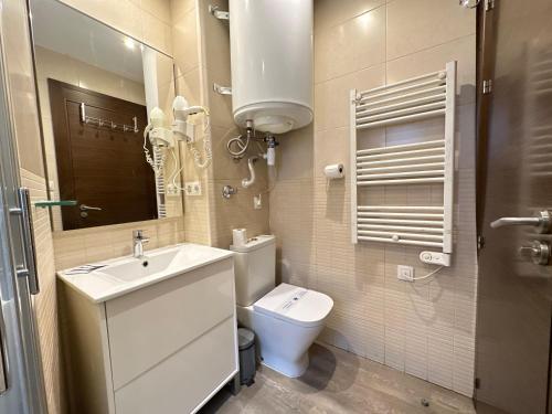 a bathroom with a sink and a toilet and a mirror at Sky 401 by CONFORTSKY in Pas de la Casa