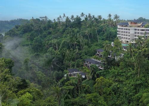 a building on top of a hill with trees at Adiwana Alas Harum in Ubud