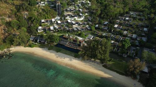 an aerial view of a resort on a beach at The Naka Phuket, a member of Design Hotels in Kamala Beach
