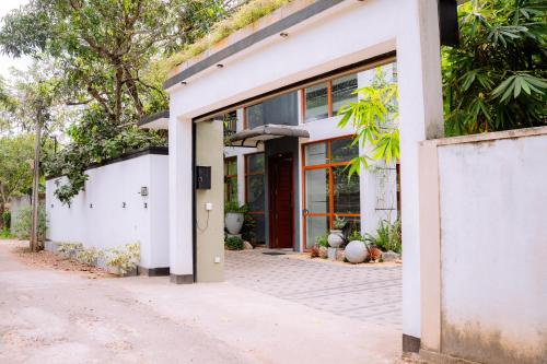 a white house with an open door at Gampaha Heritage in Gampaha