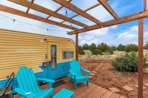 a caravan with blue chairs on a deck at Grand Canyon Stargazing Camper in Williams