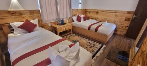 Postelja oz. postelje v sobi nastanitve Hotel Sheryang
