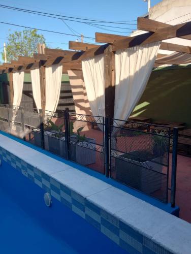 a fence on the side of a swimming pool at la reyna in Monte Grande