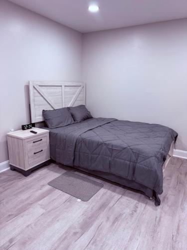 a bedroom with a large bed and a nightstand at Entire Private Studio JFK in Morris Park