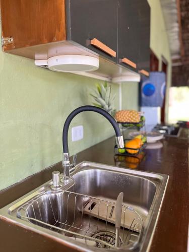 a sink with a faucet in a kitchen at Porto Taipu in Marau