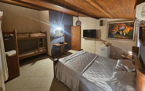 a bedroom with a bed and a tv in it at Porto Taipu in Marau