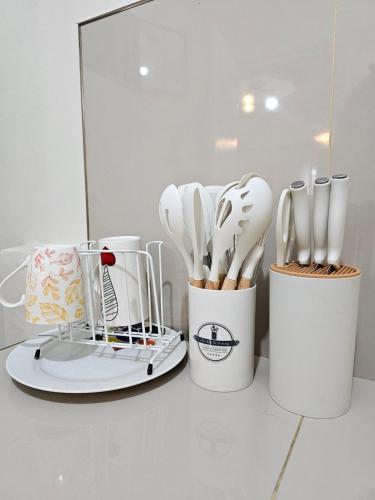 a group of utensils in white containers on a counter at Raed Homestay by ASH in Biñan