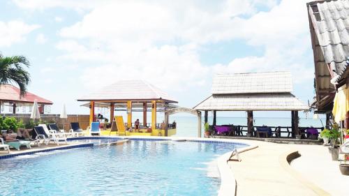 a pool at the resort with a gazebo at Lanta New Beach Bungalows - SHA Plus in Ko Lanta
