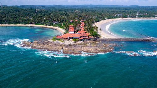 an aerial view of a resort on an island in the ocean at The wave Dickwella in Dickwella