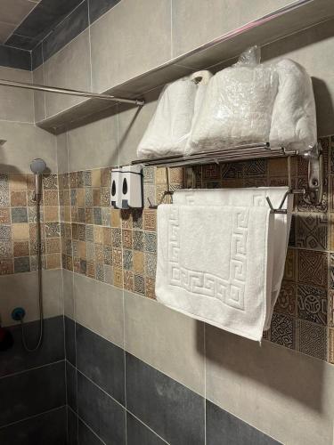 a bathroom with towels on a shelf in a shower at Villas with direct sea views and apartments with partial sea views in Miami, Alexandria, Al Safwa Tower, in Alexandria