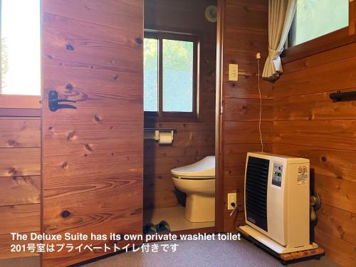ein Badezimmer mit Toilette und Fernseher in der Unterkunft miscu in Minakami