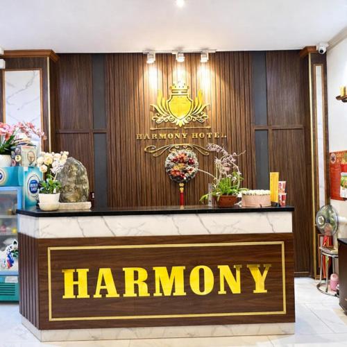 a shop front with a harromany sign on a wall at Harmony Hotel in Hanoi