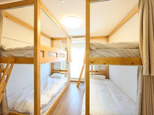 two bunk beds in a tiny house at K-Stay TOKYO HANEDA in Tokyo