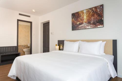 Ένα ή περισσότερα κρεβάτια σε δωμάτιο στο Calista Sai Gon Hotel