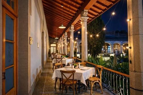 a restaurant with tables and chairs on a balcony at Hotel Express Quinta Soledad in Mexico City