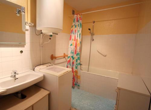 a bathroom with a sink and a toilet and a shower at Négrignas in Augne