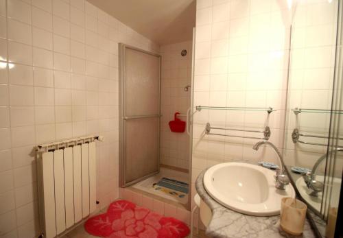 a bathroom with a toilet and a sink and a shower at Négrignas in Augne