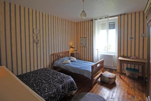 a bedroom with two beds and a window at Serre in Augne
