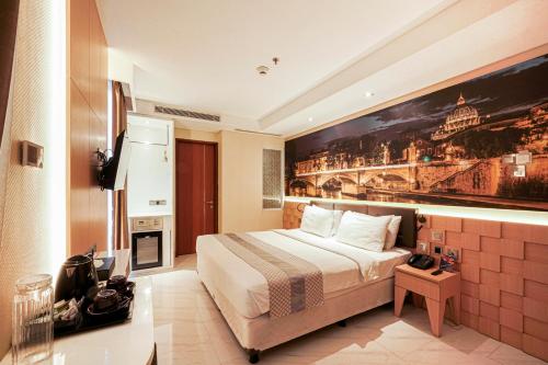 a hotel room with a bed and a painting on the wall at Sunerra Express Grand Viveana Bandung in Bandung