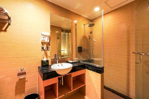 a bathroom with a sink and a shower at Sunerra Express Grand Viveana Bandung in Bandung