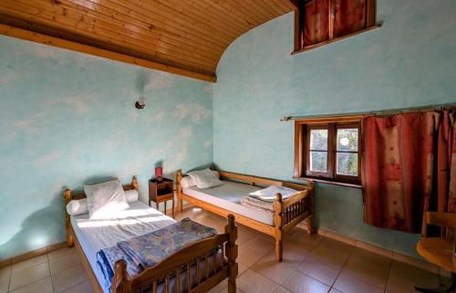 a room with two beds and a window at Les landes in Champnétery