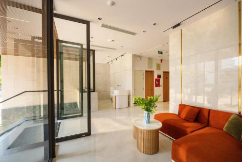 a living room with a couch and a table at Anora Home by BRIO in Danang