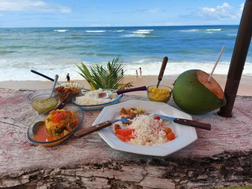 a table with a plate of food on the beach at Hacienda del Mar Resort Condominio 205 in Cancún