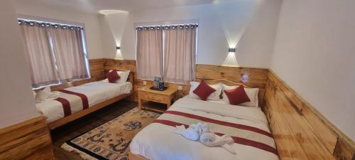Postelja oz. postelje v sobi nastanitve Hotel Sheryang