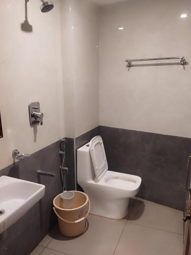 a bathroom with a toilet and a sink at Hotel Alankar in Kanyakumari