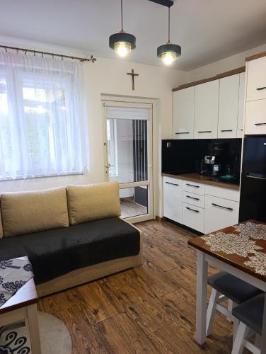 a living room with a couch and a kitchen at Czesławka in Zawoja