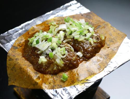 a pizza sitting on top of a piece of tin foil at Miyamaso in Takayama
