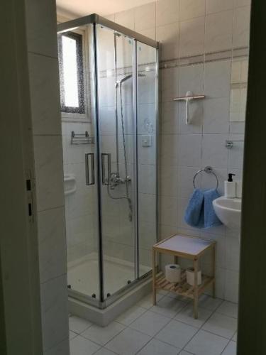 a bathroom with a shower and a sink at Seaclusion Vacation Villa in Pomos