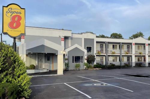a hotel with a parking lot in front of it at Super 8 by Wyndham Belleville St. Louis Area in Belleville