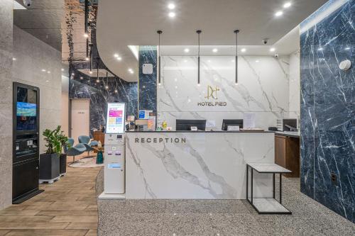 a lobby with a reception counter in a building at Hotel PIED Suseong in Daegu