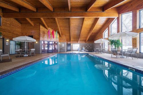 a swimming pool in a building with a wooden ceiling at AmericInn by Wyndham Sioux Falls in Sioux Falls