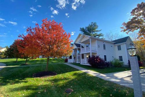 a white house with a tree in the yard at Golden Gables Inn Dazzler Select by Wyndham in North Conway