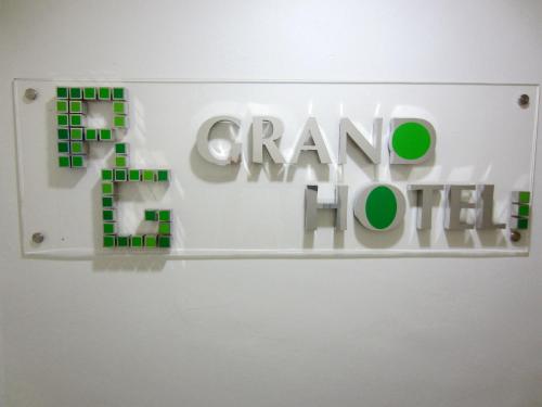 a sign with the words grand tour on a wall at RG Grand Hotel in Parit Raja