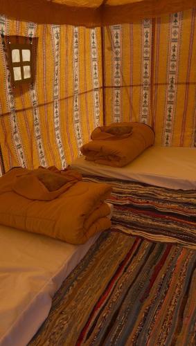 two beds with pillows on them in a room at مبيت في الصحراء in Tunis