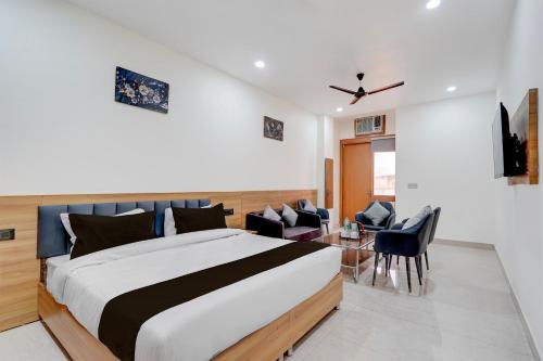 a bedroom with a bed and a table and chairs at Townhouse Roorkee Bypass in Roorkee